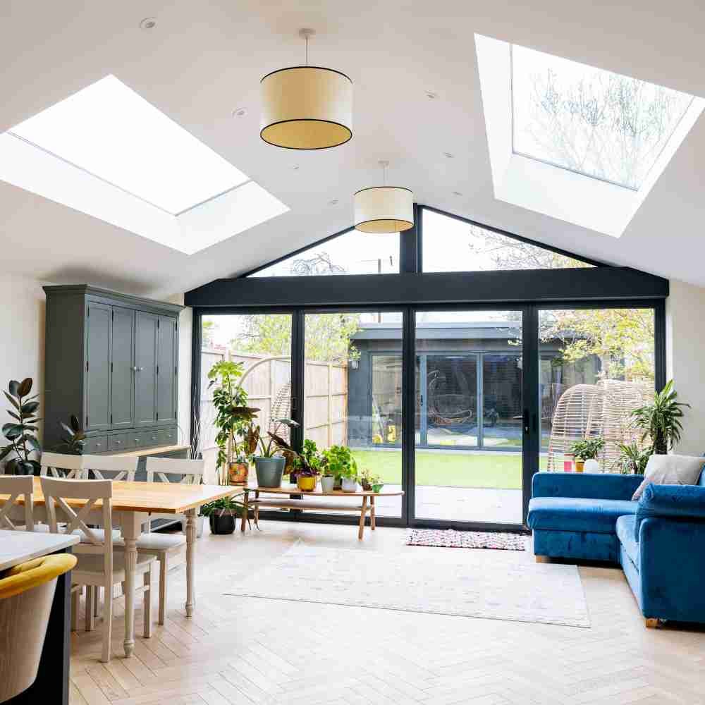 Illustrative bright home extension with rooflights and wide garden doors