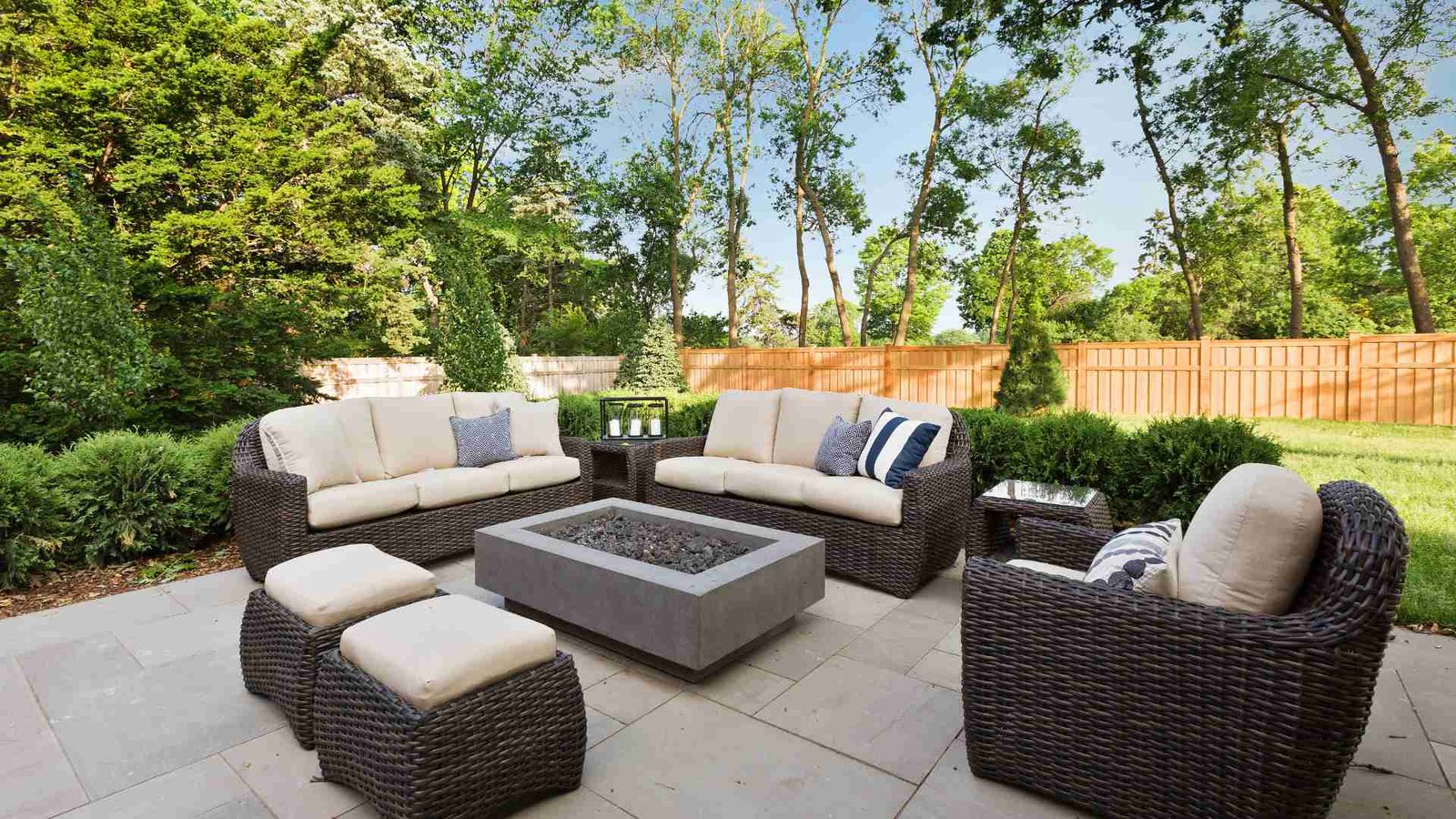 Illustrative paved garden patio with outdoor seating and a central fire table